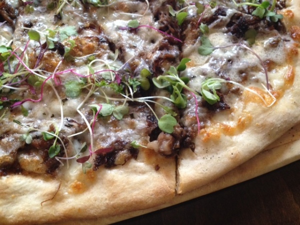Take a bite out of the Short Rib Pizza, which boasts fig pesto, three cheeses, rosemary, and micro greens
